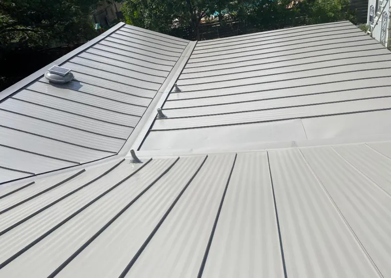 Solar attic fan installed on a metal roof for Roof Ventilation in Marshalltown